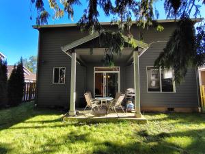 a patio with chairs and a table in front of a house at Evergreen House in Vancouver