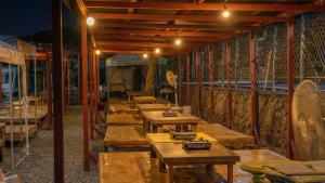 a row of wooden tables in a room with a tent at Gapeong Jason Spa Pension in Gapyeong