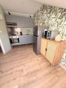 a kitchen with a stainless steel refrigerator and a counter at Appartement neuf à louer in Moyenmoutier