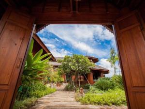 a view through a door of a house with a pathway at Huan Aumpron Resort in Ban Kha Ngam +45 photos