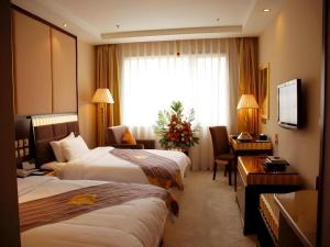 a hotel room with two beds and a desk at Lhasa Hotel in Lhasa +285 photos