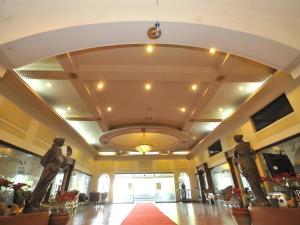 a lobby with two statues in the center of a building at Queen Margarette Hotel in Silañgang Isabang +288 photos