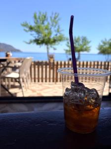 a drink with a straw sitting on a table at Adrasan blue bay hotel in Kumluca