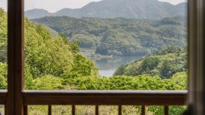 a view of a lake from a window at Gapyeong Art Pension in Gapyeong
