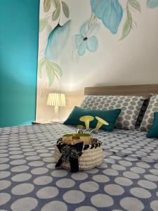 a bedroom with a bed with a flower mural on the wall at Massanè Casa Vacanza in Ginosa