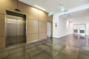 an empty hallway with a door in a building at 18th Floor Seaview Executive Style King Bed with Pool and Gym in Darwin