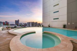 a swimming pool on the roof of a building at 18th Floor Seaview Executive Style King Bed with Pool and Gym in Darwin +21 photos