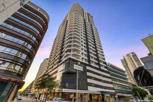 a tall building in the middle of a city at 18th Floor Seaview Executive Style King Bed with Pool and Gym in Darwin