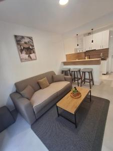 a living room with a couch and a table at Apartments Radoman in Ulcinj