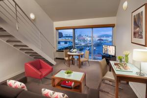 a living room filled with furniture and a large window at Somerset on the Pier Hobart in Hobart