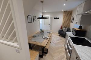 a kitchen and living room with a wooden table in a room at Harbourside, Shetland Islands in Lerwick