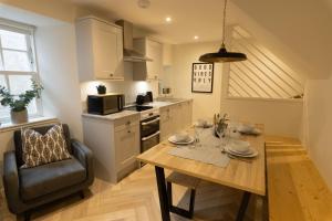 a kitchen with a table and a dining room at Harbourside, Shetland Islands in Lerwick