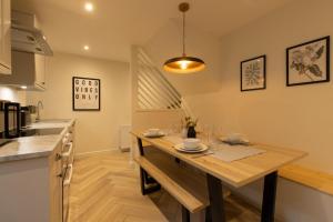 a kitchen with a wooden table in a room at Harbourside, Shetland Islands in Lerwick