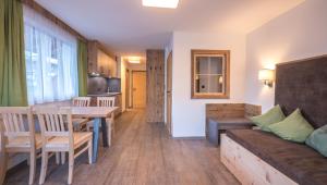 a living room with a table and a couch at Hotel & Apart Central in Fügen