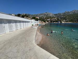 a group of people in the water at a beach at Apartment BELLA in Karlobag
