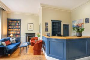 a living room with a blue island in the middle at The Rodney Hotel in Bristol