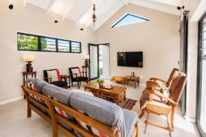 a living room with a couch and a table at Sandy Fingers Apartment in Plettenberg Bay