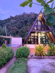 a house with a mountain in the background at Casa Carmelita in Batangas City