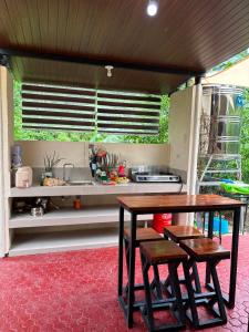 a kitchen with a table and a sink at Casa Carmelita in Batangas City