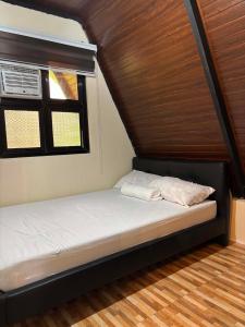 a small bed in a room with a window at Casa Carmelita in Batangas City