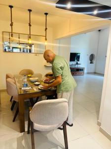 a man standing at a table with a plate of food at Villa 121 in Kandy