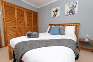 a bedroom with a large bed with a wooden headboard at North Harbour View, Shetland Islands in Lerwick