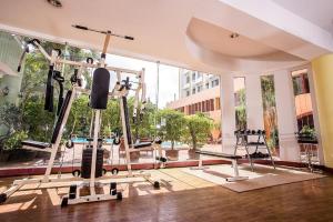 a gym with two tread machines and a large window at Wangtai Hotel in Suratthani