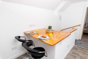 a small kitchen with a wooden table and two chairs at Mowbray's Nook, Shetland Islands in Lerwick