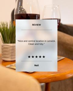 a bottle of red wine sitting on a table at Mowbray's Nook, Shetland Islands in Lerwick