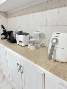 a kitchen counter with a mixer and other appliances on it at Waterfront vip master room in Muscat