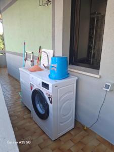 a washing machine with a blue hat on top of it at BubiBea in Silvi Marina