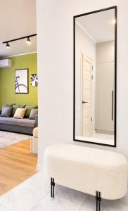 a mirror in a living room with a ottoman at ЖК "Женис III" in Kokshetau +4 photos