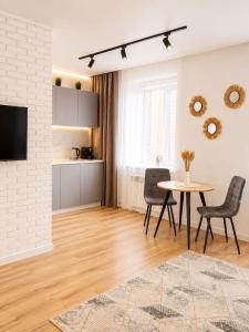 a living room with a table and chairs at ЖК "Женис III" in Kokshetau