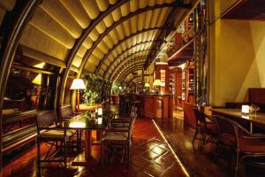 a restaurant with tables and chairs and a ceiling at Regency Art Hotel in Macau