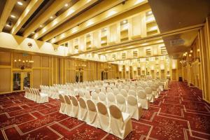 a large hall with white chairs in it at Regency Art Hotel in Macau