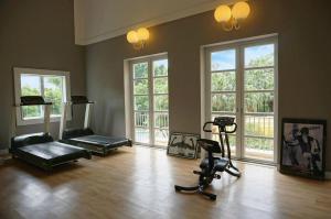 an empty room with a gym with exercise equipment and windows at Regency Art Hotel in Macau