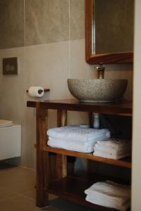 a bathroom with a sink and towels on a shelf at Sabay Koh Rong in Koh Rong Island