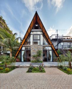 a house with a triangular roof at Cát Bà Sena Valley Retreat in Xuan Dam