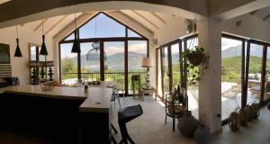 a kitchen with a large window and a table with chairs at Perfect destination !!! in Ðuraševići