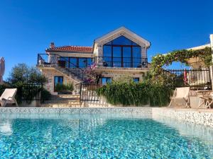 a house with a swimming pool in front of a house at Perfect destination !!! in Ðuraševići