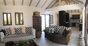 a living room with two couches and a kitchen at Perfect destination !!! in Ðuraševići