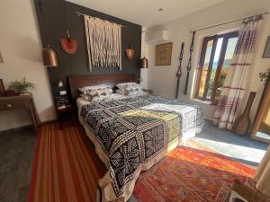 a bedroom with a bed with a comforter on it at Perfect destination !!! in Ðuraševići +56 photos