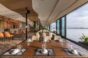 a restaurant with a view of the water at Van Phat Riverside Hotel in Can Tho