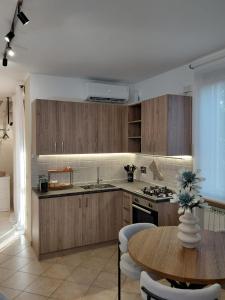 a kitchen with wooden cabinets and a wooden table with a tableablish at Beltà di Spello in Spello
