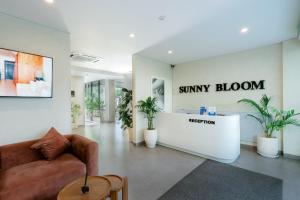 a lobby with a waiting area with a couch and a salon at Sunny Aparts 1 by Betterplace in Canggu