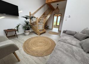 a living room with a couch and a table at Rancho Lawendowe in Szczytna