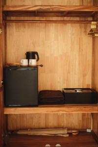a shelf with a coffee maker and a pot on it at Sabay Koh Rong in Koh Rong Island