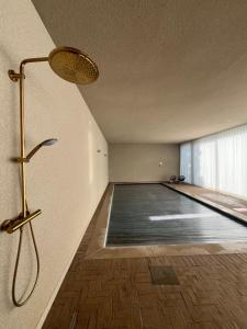 an empty room with a swimming pool in a building at Biervlietmolen Vakantiewoning in Diksmuide