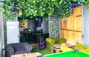 a room with a pool table and some plants at Laycon hotel and suites in Ikuata