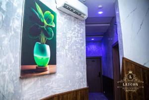 a green vase sitting on a shelf on a wall at Laycon hotel and suites in Ikuata